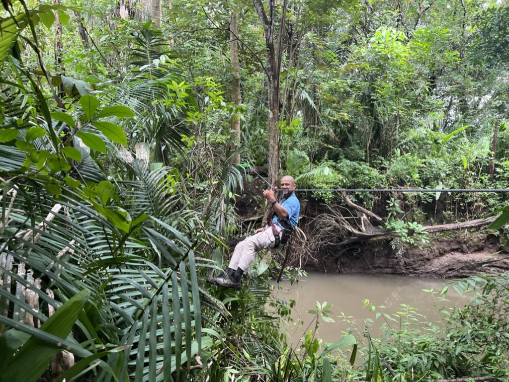 Photo of a member of the field team on a zipline